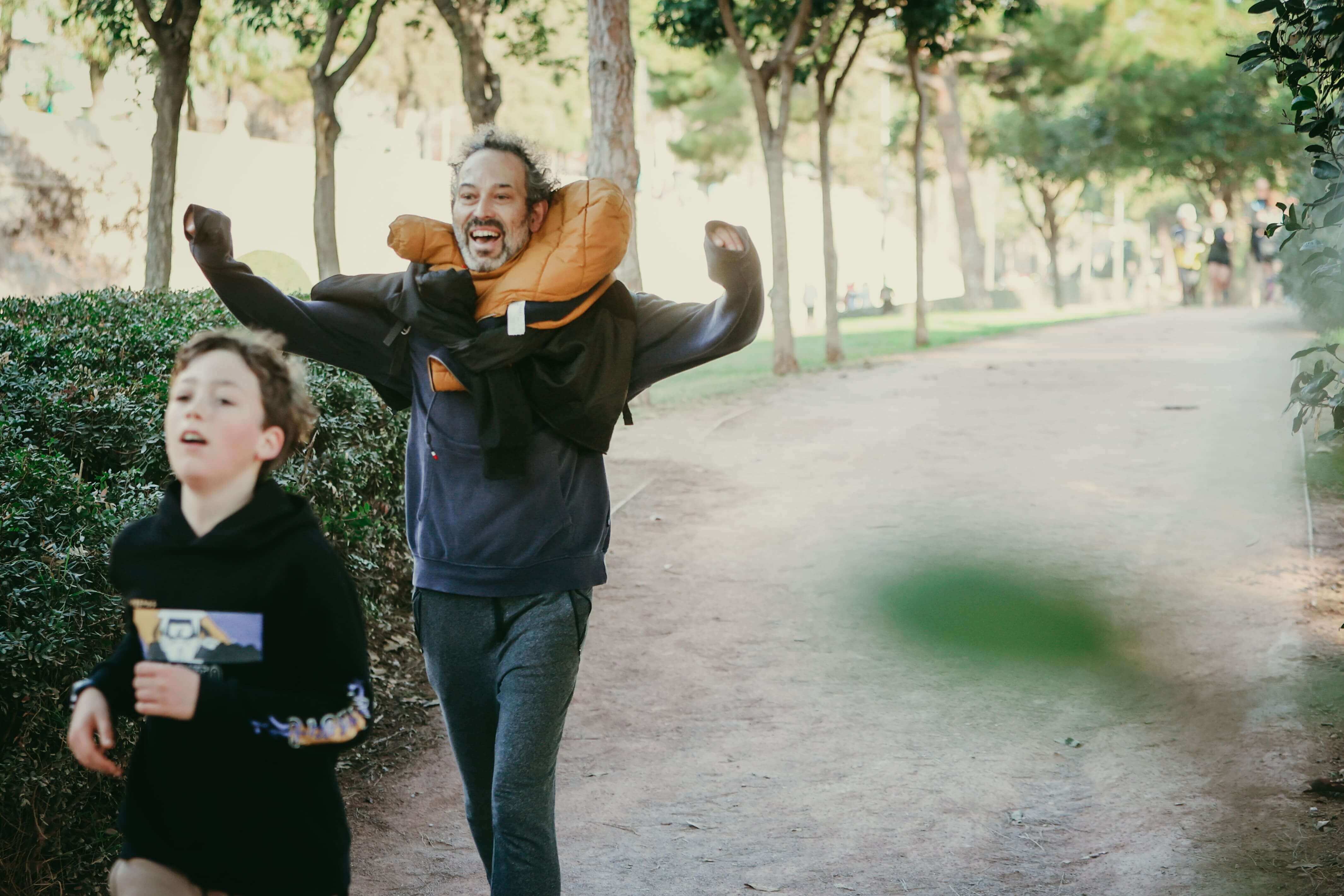 Two boys and their father running